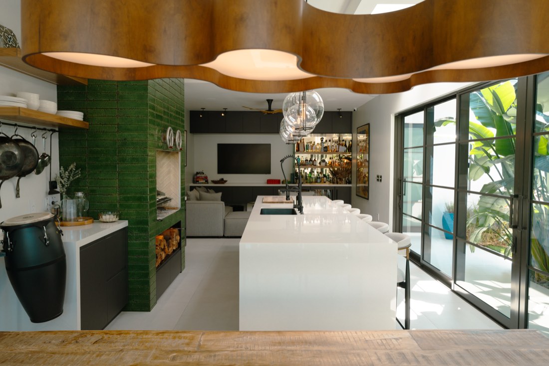 Motel gazebo kitchen and bar with retro-inspired green tile fireplace